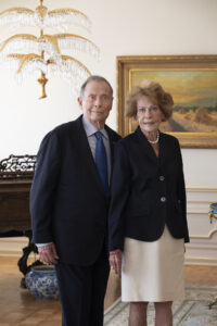 An older man dressed in a dark suit and tie stands next to his wife, an older woman with brown hair and a dark jacket and white skirt. John and Marcia Price have committed $50 million to the University of Utah's College of Engineering