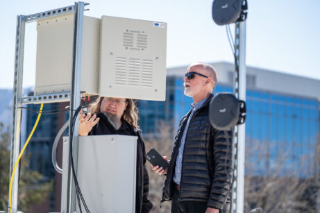 Kobus Van Der Merwe and Kirk Webb adjust wireless transmitters on a building roof