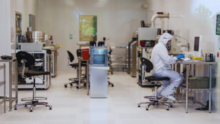 A researcher works in a cleanroom