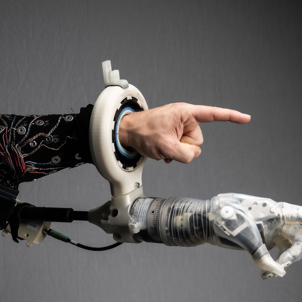 A robotic hand mimics the gesture of a human one