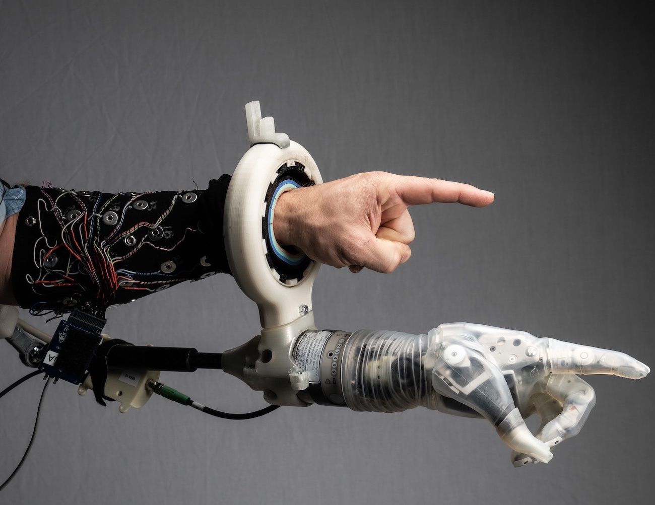 A robotic hand mimics the gesture of a human one