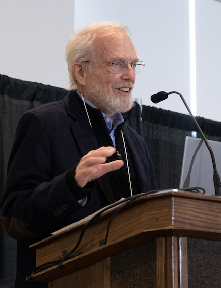 John Warnock speaking at a lectern