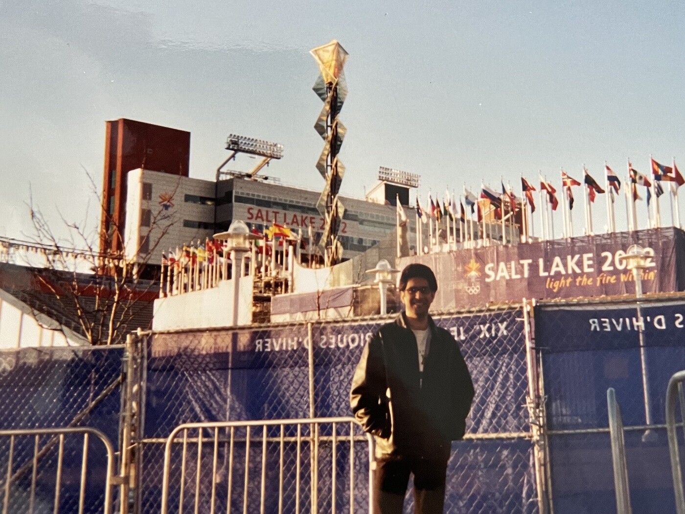 Omid Saadati poses in front of Rice Eccles Stadium as it is prepared for the 2002 Winter Olympics