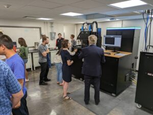 Image of Dr Ashley Spear and PCE Dean of Engineering Richard Brown gathered around a lab table