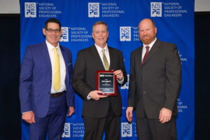 Chad Hogan poses with a plaque