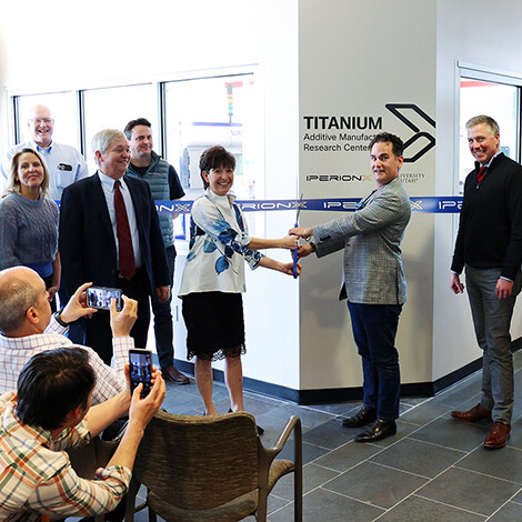 Members of IperionX and the Materials Science and Engineering Department cut the ribbon in front of a new lab.
