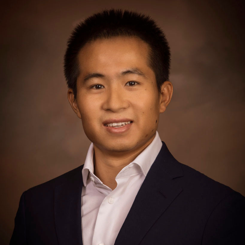 Headshot of Haohan Zhang, he is in a professional blazer and shirt against a neutral background