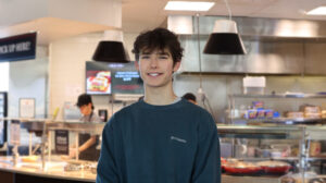Jack Urness poses in front of a kitchen