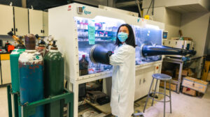 Yana Qin working at a glove box.