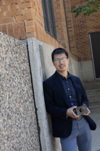 Tao Gao holding a block of iron